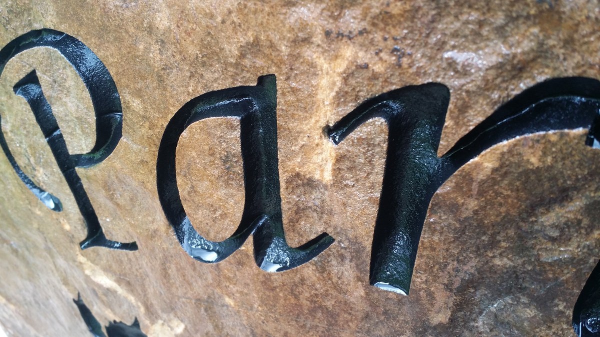 Deep sandblast stone engraving filled with black Lithichrome paint